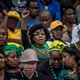 A woman raises her fist during the funeral for Winnie Madikizela-Mandela, held at Orlando Stadium on April 14, 2018, in Soweto, South Africa.